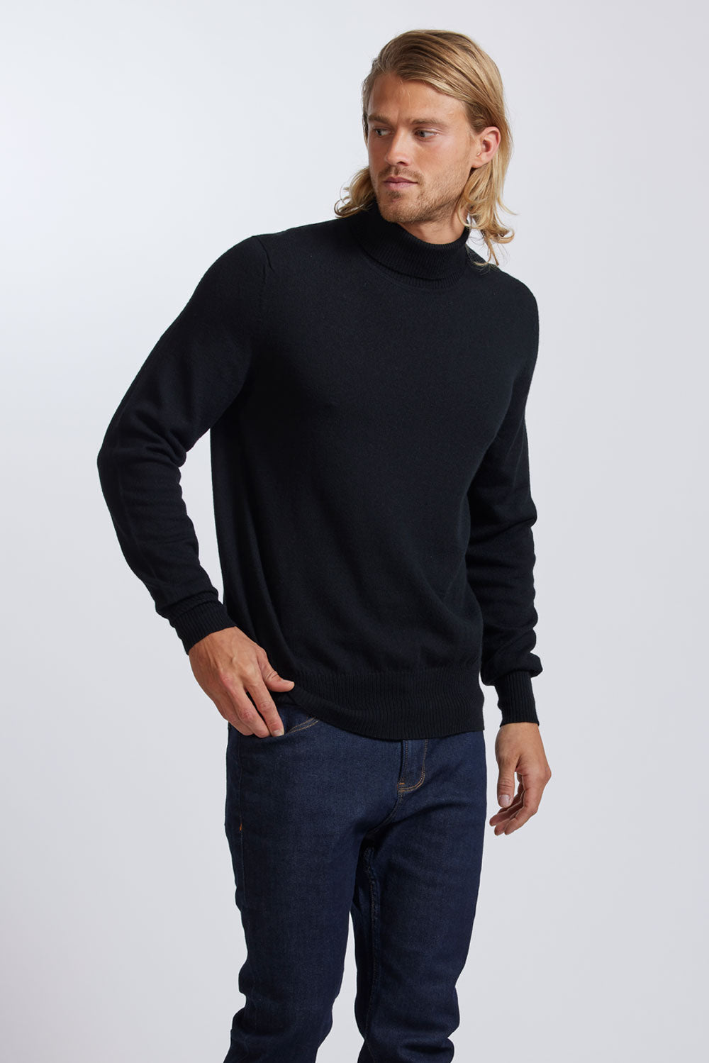 Man wearing a black polo neck merino sweater