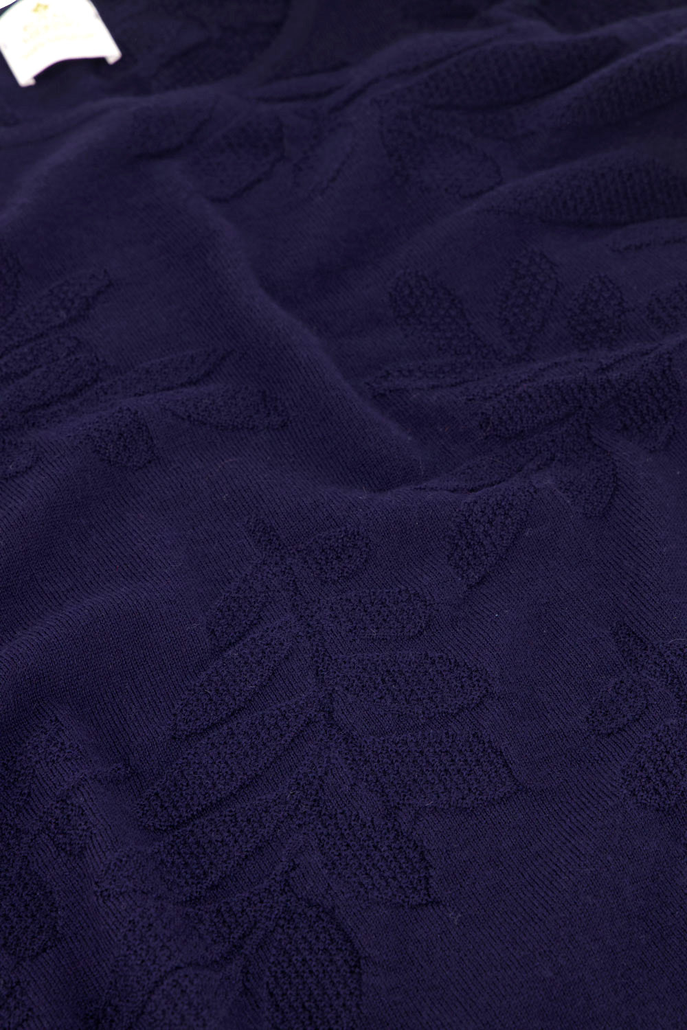 Detail of navy sweater with floral patterns